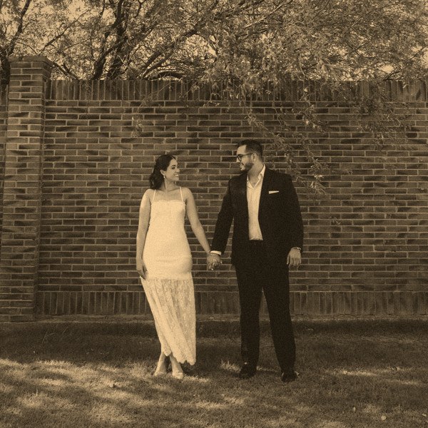 Jocelyn Denisse y Luis Humberto frente a un muro de ladrillo